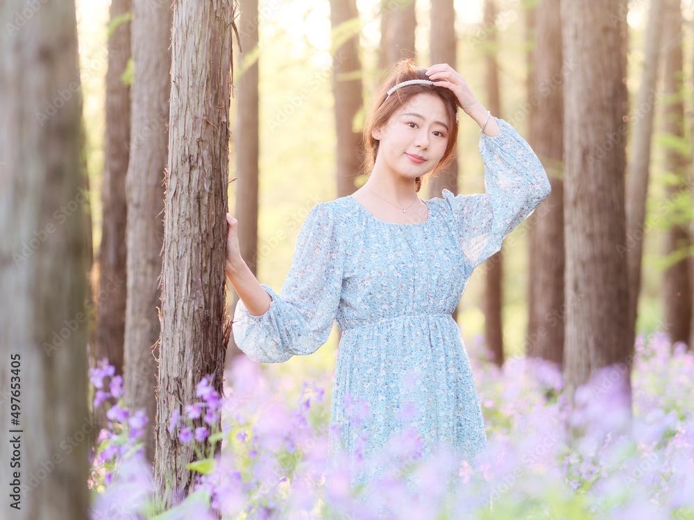 Portrait of elegant Chinese girl in dress enjoy carefree time in forest park in sunny day. Outdoor fashion portrait of glamour young Chinese cheerful stylish woman. Portrait of elegant Chinese girl in dress enjoy carefree time in forest park in sunny day. Outdoor fashion portrait of glamour young Chinese cheerful stylish woman.