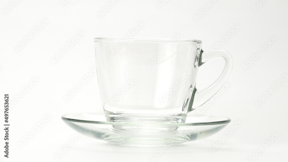 Pouring hot tea into transparent glass on white background. Closeup view of hot tea being poured in a cup on white. Pouring hot tea into transparent glass on white background. Closeup view of hot tea being poured in a cup on white.