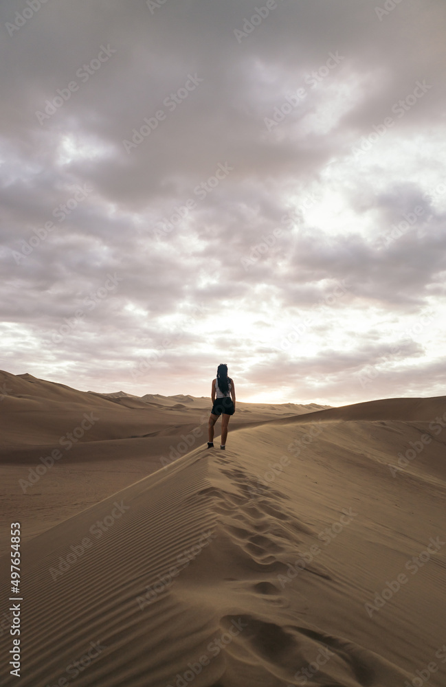 Woman walking in desert Woman walking in desert