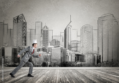 King businessman in elegant suit running and drawn cityscape silhouette at background