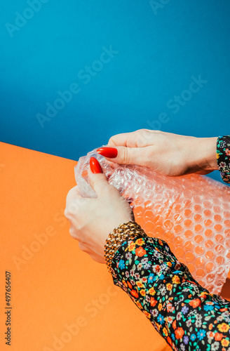Hands popping bubble wrap