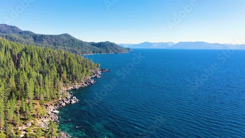 Lake George, New York Crystal Clear Blue Waters And Lush Pine Tree Forest And With Mountains and Rocky Shoreline - aerial drone reveal photo