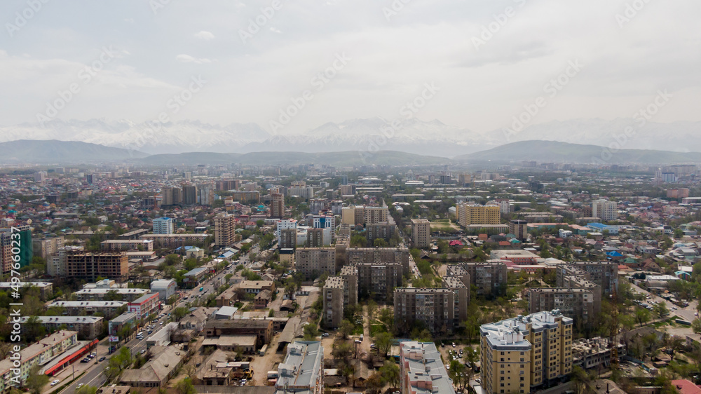 Aerial view of Bishkek city with snowy mountains in the background