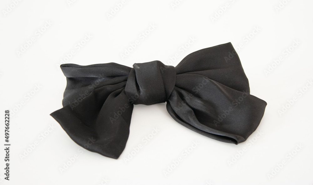 Black cute silk bow. Barrette. Isolated on a white background. Horizontal format Black cute silk bow. Barrette. Isolated on a white background. Horizontal format