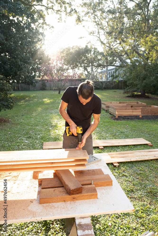 Man Using Power Tool Drill on Home DIY Project Man Using Power Tool Drill on Home DIY Project