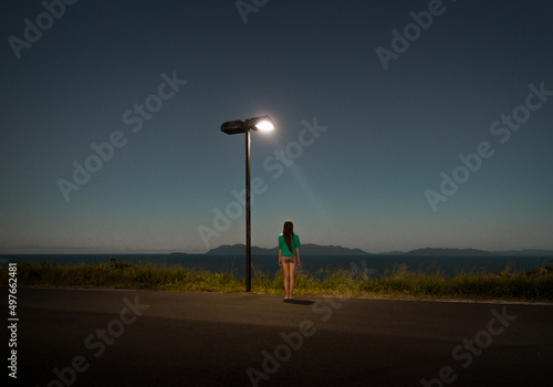Standing woman on dreamlike lookout photo
