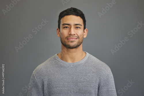 First you have to believe in yourself. Shot of a handsome young man standing against a grey background. photo