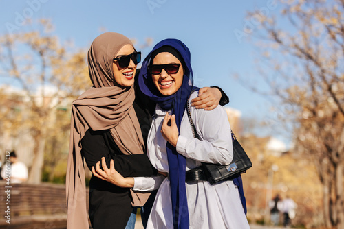 Cheerful muslim women in trendy clothes and sunglasses photo