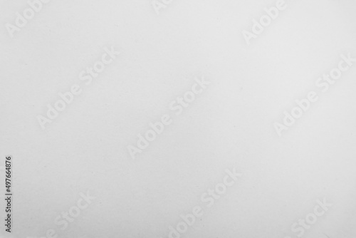 White recycled craft paper texture as background. Grey paper texture. Cardboard design element.