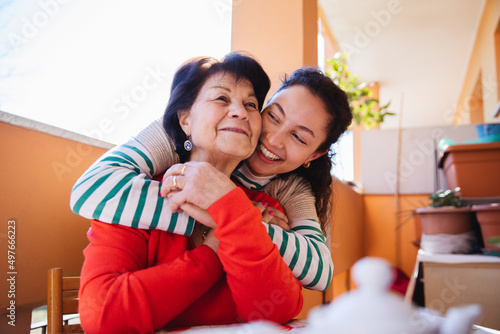 Moment of tenderness between granddaughter and grandmother photo