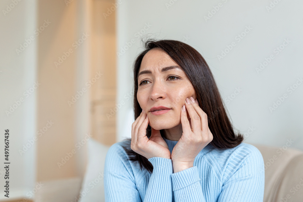 Portrait of unhappy Asian woman suffering from toothache at home. Healthcare, dental health and problem concept. Stock photo Portrait of unhappy Asian woman suffering from toothache at home. Healthcare, dental health and problem concept. Stock photo