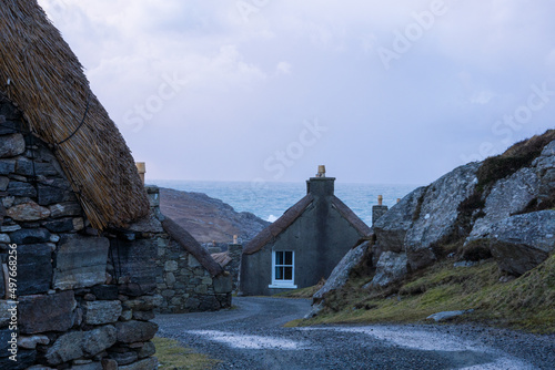 historic thatch stone houses on a wild coast