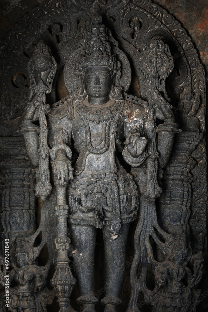 Stone Sculpture of Hindu Gods with selective focus, 12th century Hindu temple, Ancient stone art and sculptures in each pillars, Chennakeshava Temple, Belur, Karnataka, India.