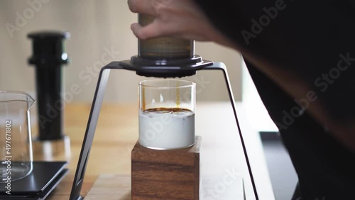 drop of espresso shot on chilled milk, home brewing process 