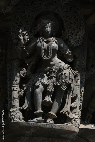 Stone Sculpture of Beautiful Female (Madanikas) with selective focus, 12th century Hindu temple, Ancient stone art and sculptures in each pillars, Chennakeshava Temple, Belur, Karnataka, India. photo