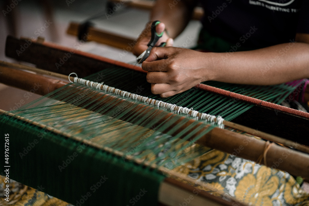 A traditional weaving is done by a lady during weaving stories event in Ubud, Bali