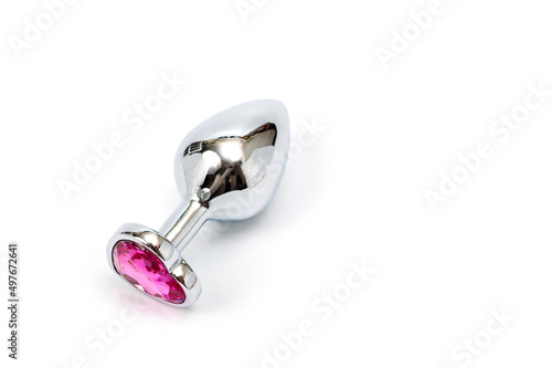 фотографія Metal butt plug with a decorative pink heart-shaped stone at the end