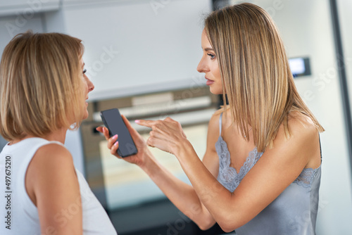 Nice two adult girls in the housethe are arguing with cell phone