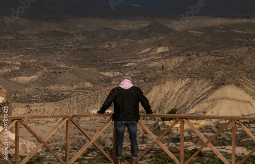 Rear view of adult man standing against mountain. Almeria, Spain