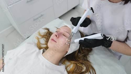 Cosmetic procedure to improve the condition of the skin of the face with microcurrents. Cosmetology and professional facial skin care.