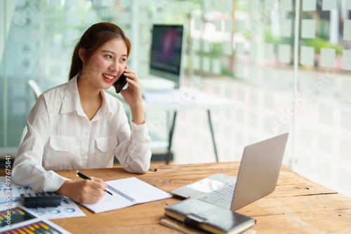 data analysis, plan, marketing, accounting, audit, asian business woman holding smart phone of planning marketing use statistical data sheet and computer to present marketing plan project at meeting.