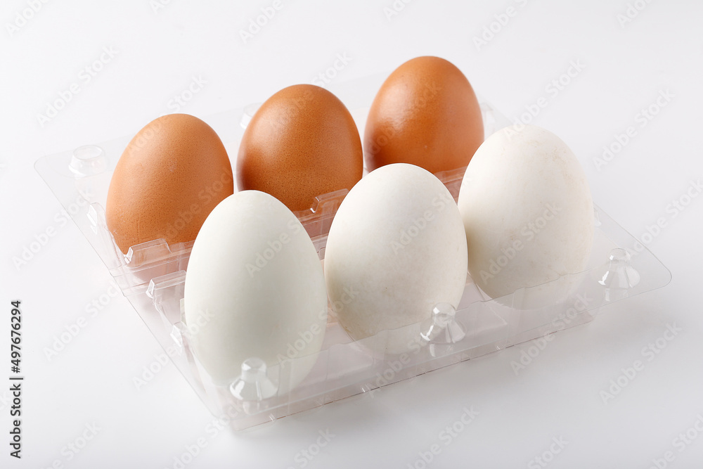 3 Duck eggs (White color) and 3 chicken eggs (Brown color) arranged in plastic packaging boxes for sale. 3 Duck eggs (White color) and 3 chicken eggs (Brown color) arranged in plastic packaging boxes for sale.