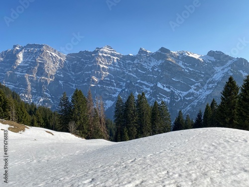 The alpine mountain range Glärnisch in the Swiss massif of Glarus alps and over the Klöntalersee reservoir lake (Kloentalersee or Klontaler lake) - Canton of Glarus, Switzerland (Schweiz) photo