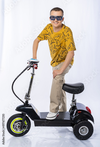 guy in an electric car. a man in the studio on a tricycle. White background. electric scooter