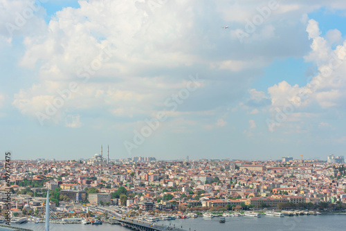 View of Istanbul on a sunny summer day with a bright blue sky with white clouds and a flying plane. Travel concept