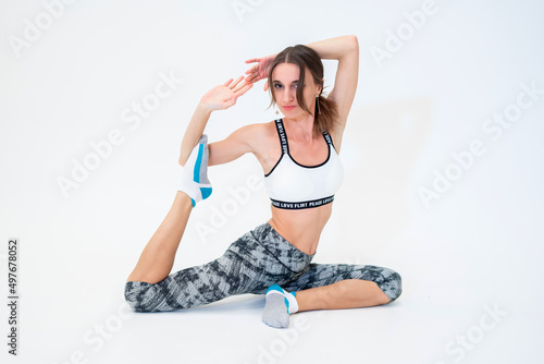Beautiful young woman goes in for sports on a white background.