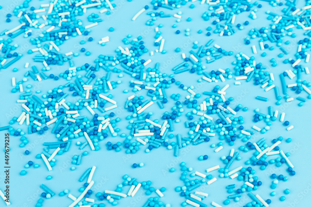 Sugar sprinkles in shape of star moon sticks on light blue background. Spase for text. Easter concept. Sugar sprinkles in shape of star moon sticks on light blue background. Spase for text. Easter concept.