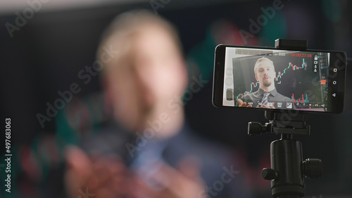 Stock trading businessman influencer video recording with smartphone