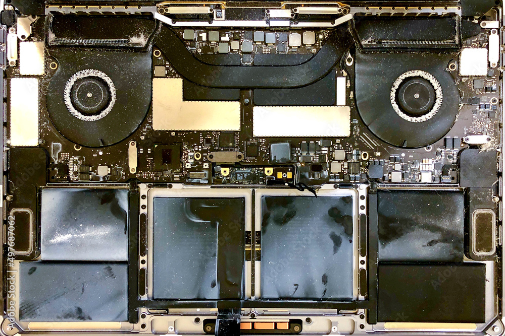Top view on disassembled Laptop with motherboard covered with dust, technology fix concept Top view on disassembled Laptop with motherboard covered with dust, technology fix concept