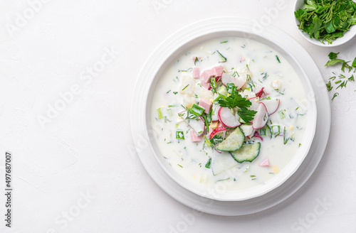 Schilderij op canvas Summer, cold okroshka soup with vegetables, sausage, herbs and kefir on a white background