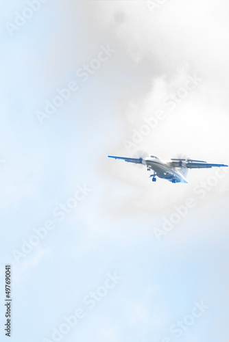 The plane is about to land on the runway with a bright blue sky background. Travel background. Passenger airliner. Business trip. Commercial aircraft. copy space for aviation and air transportation. 