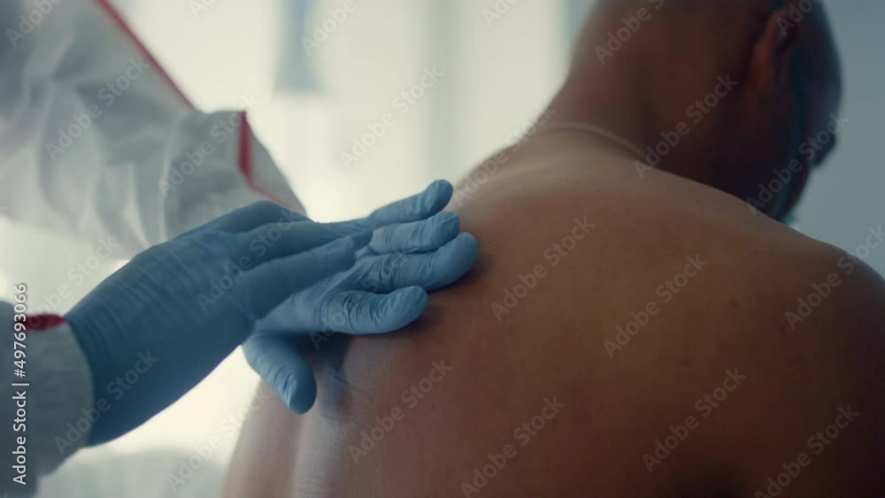 Closeup physician examining back manually. Unknown doctor check for pneumonia. Closeup physician examining back manually. Unknown doctor check for pneumonia.
