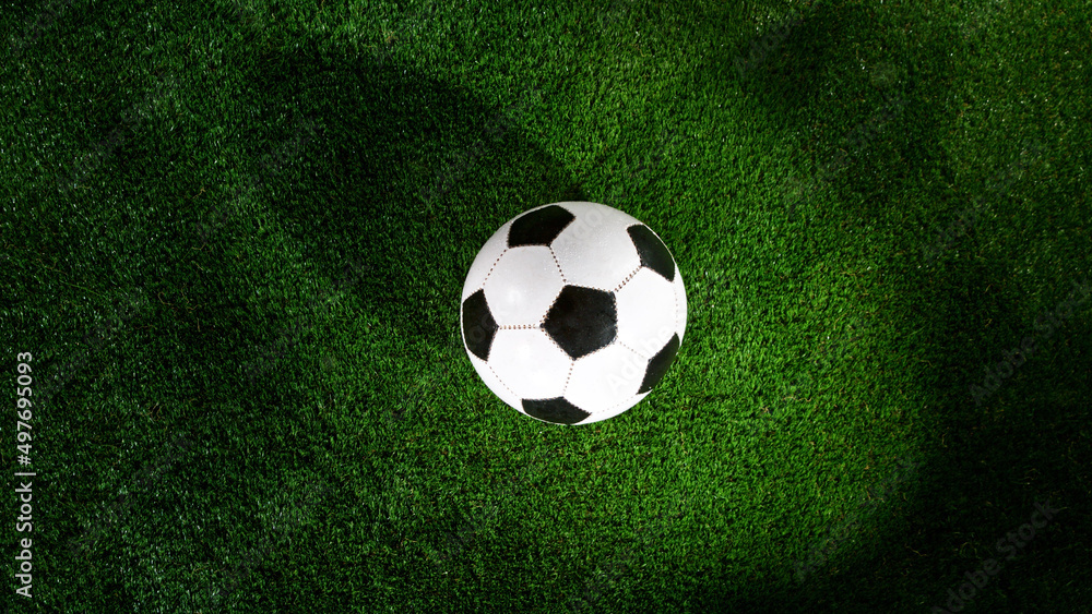 Naklejka premium Soccer ball placed on grass, top shot.