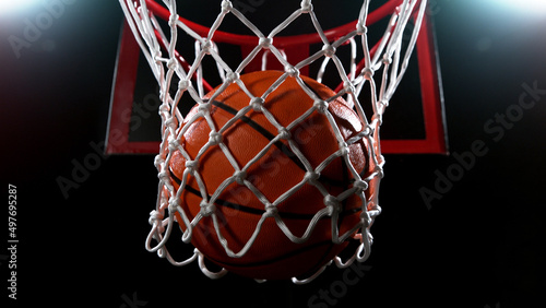 Basketball going through the basket on black backgorund © Jag_cz
