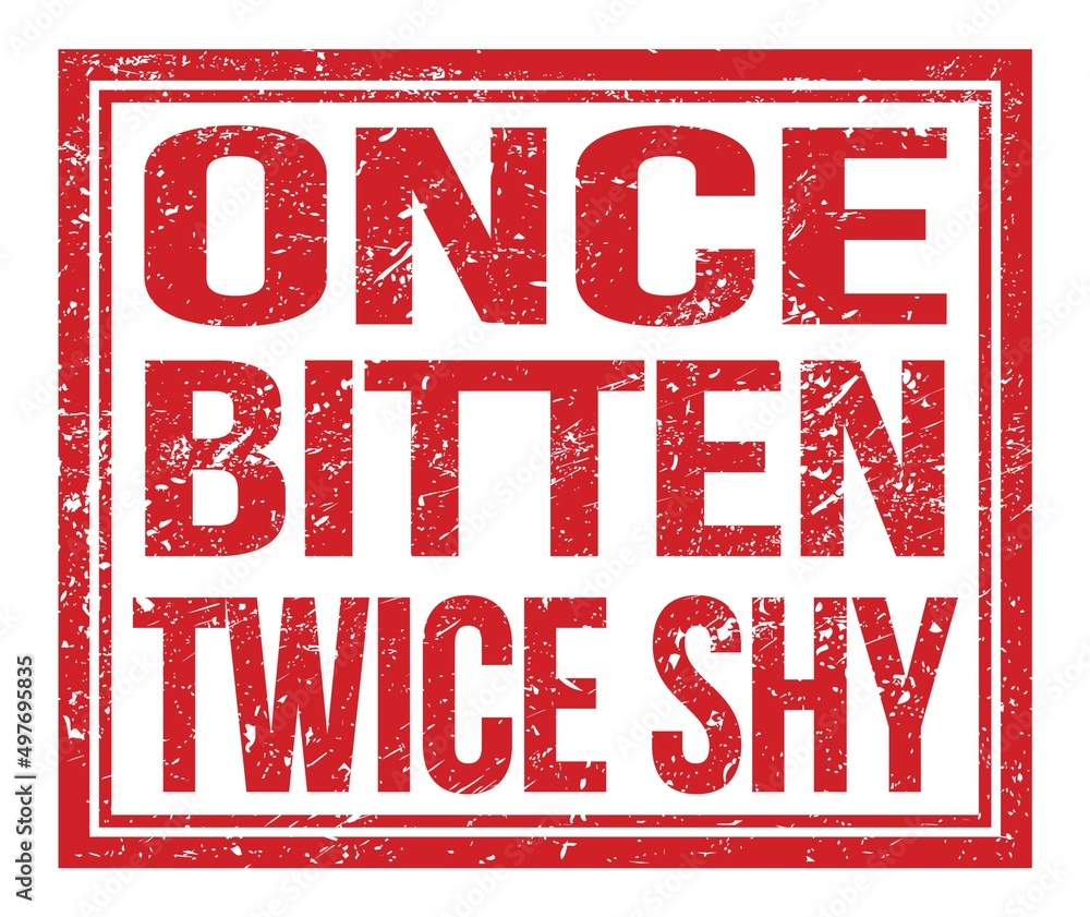 ONCE BITTEN TWICE SHY, text on red grungy stamp sign ONCE BITTEN TWICE SHY, text on red grungy stamp sign