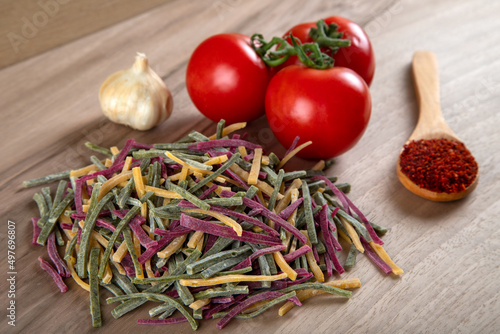 Traditional Turkish colors noodles with tomato, garlic and pepper on wooden background	 photo