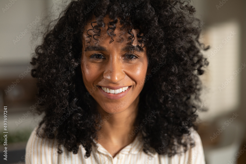 Cinematic authentic close up shot of young happy attractive brazilian woman is smiling in camera in kitchen at home. Cinematic authentic close up shot of young happy attractive brazilian woman is smiling in camera in kitchen at home.