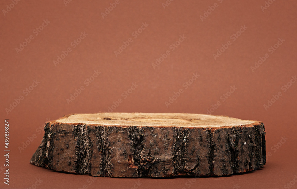 authentic natural wooden podium on brown background, eco scene for presentation, copy space, sawn cut authentic natural wooden podium on brown background, eco scene for presentation, copy space, sawn cut