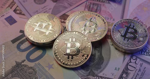 Gold and Silver Bitcoin cryptocurrency on US Dollar banknotes. Paper money trading with digital crypto assets