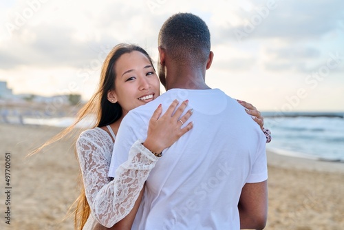 Young loving couple hugging on the beach