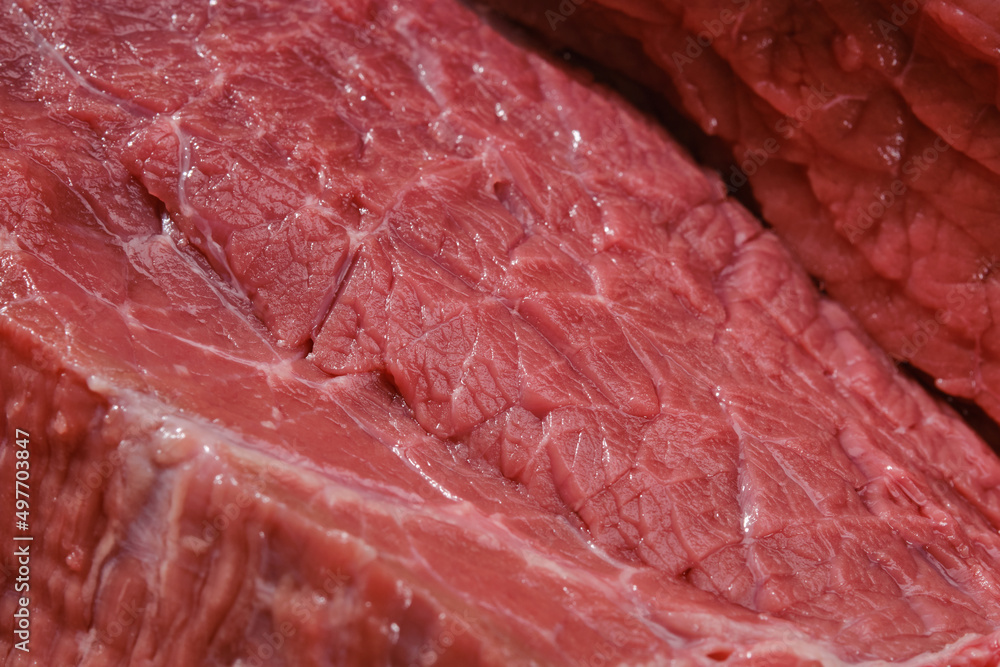 Raw beef meat on a cutting board. Cut out of raw beef fillet. Shallow depth of field Raw beef meat on a cutting board. Cut out of raw beef fillet. Shallow depth of field