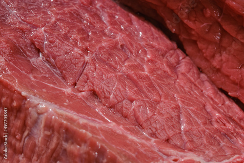 Raw beef meat on a cutting board. Cut out of raw beef fillet. Shallow depth of field	