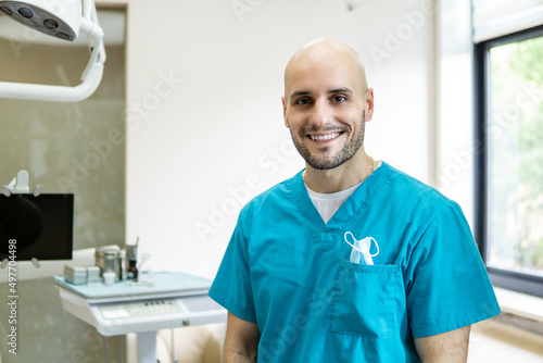 Young smiling dentist in dental clinic.