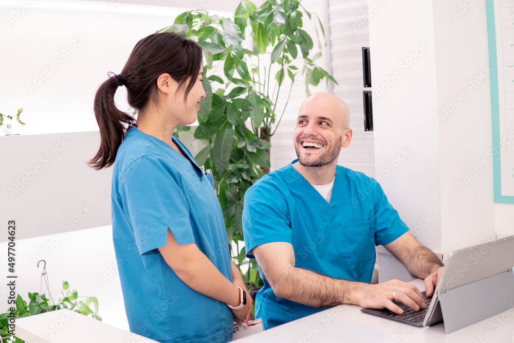 Fototapeta premium Dentist in clinic talking with nurse.