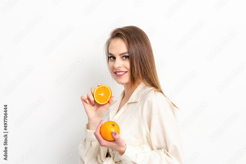 Young Caucasian smiling woman with slices orange over isolated white background Young Caucasian smiling woman with slices orange over isolated white background