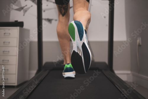 An athlete runs on a treadmill for a foot strike study.biomechanical study of the foot.